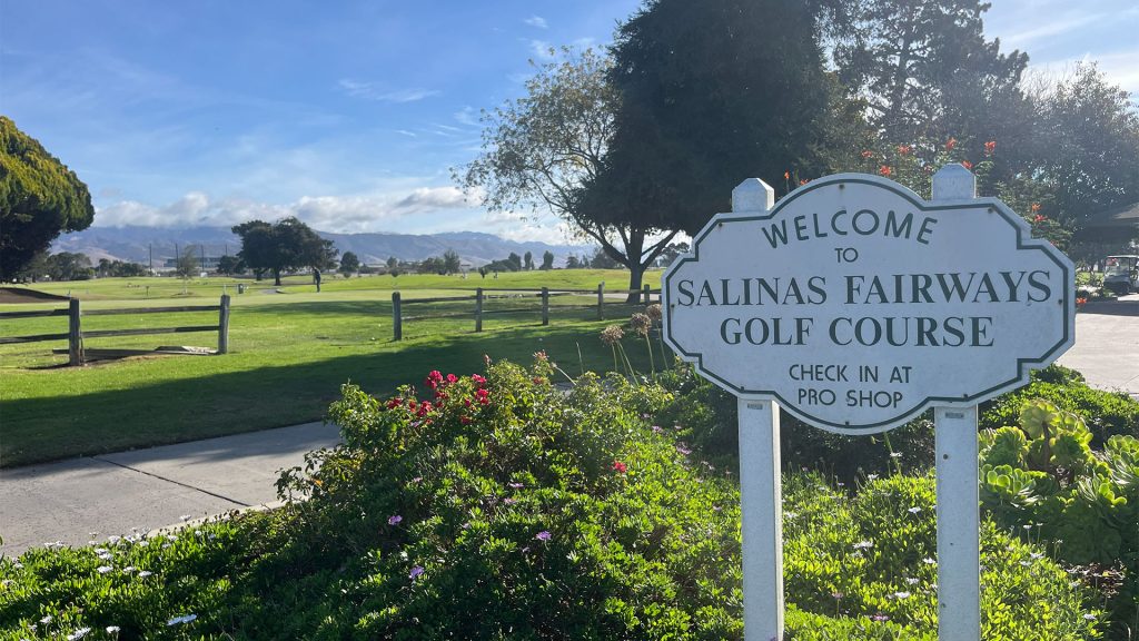 Salinas Fairways Golf Course welcome sign overlooking the course and distant mountains.